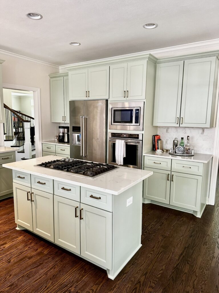 Finished cabinet painting project with white kitchen island