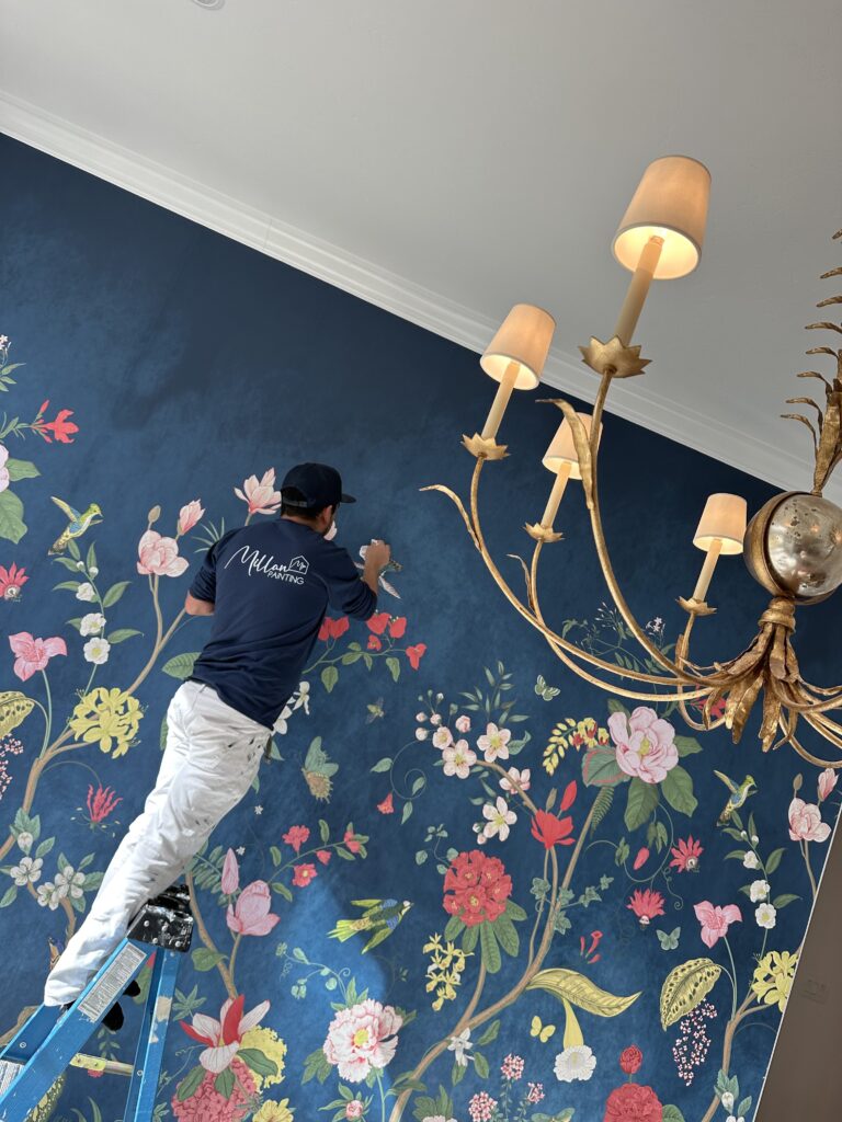 Millan Painting wallpaper installer applying floral wallpaper in Fort Worth home